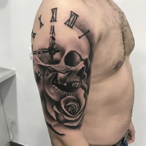Skull, watch and rose tattoo.